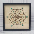 Abundance crystal grid in a black glass-front shadow box, front view