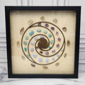 Calm and Peace crystal grid in a black glass-front shadow box, front view