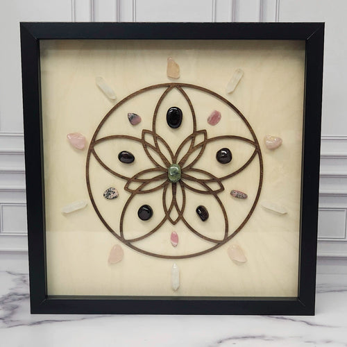 Love crystal grid in a black glass-front shadow box, front view