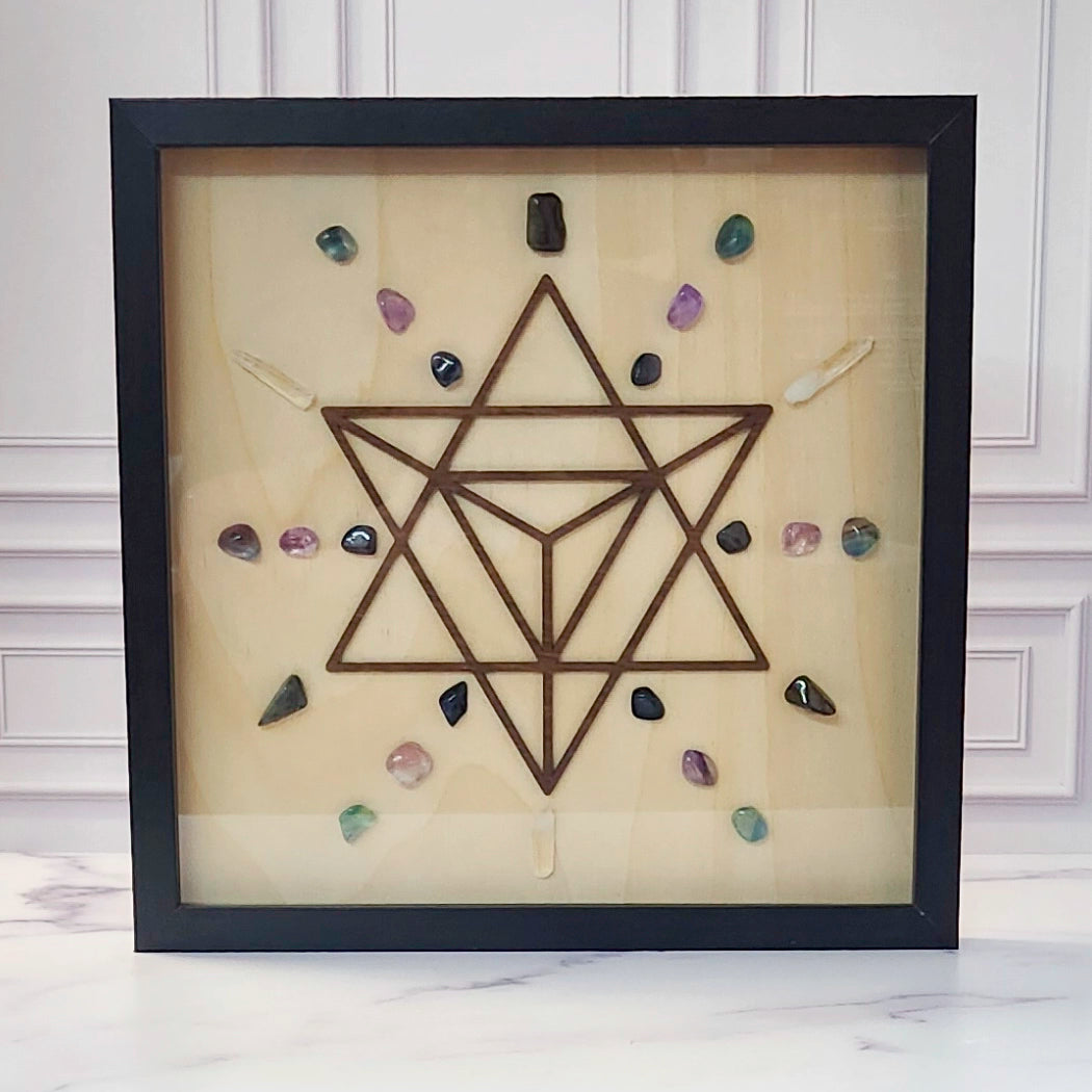 Psychic Connection crystal grid in a black glass-front shadow box, front view