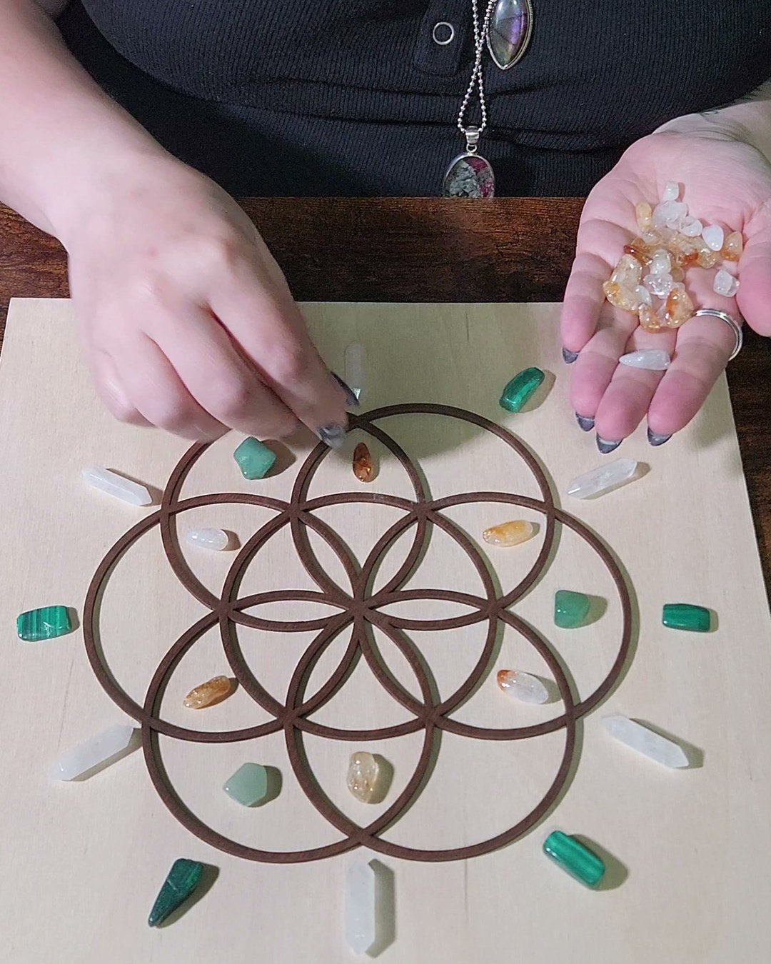 Citrine chips going onto the Abundance grid, one at a time, by hand